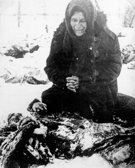 A Russian woman beside the body of her husband who was killed by the SS in Gerasimov, a village in the Rostov area.
